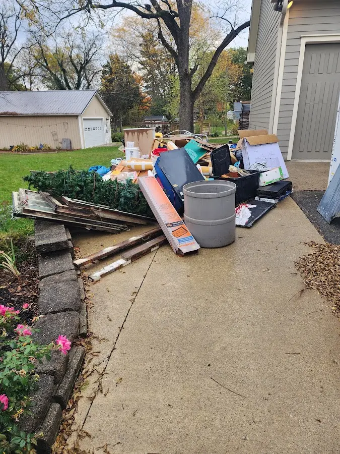 Dumpster being loaded with debris for Roofing Dumpster Rental in Carbondale